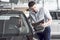 An African man who buys a new car checks a car talking to a professional vendor.