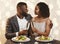 African man and woman celebrating Valentine`s Day at restaurant