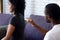 African married couple sitting on couch quarrelling at home