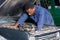 African mechanic repairing a car