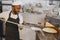 African merican man baking pizza at commercial kitchen