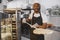 African merican man baking pizza at commercial kitchen