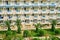 African middle Eastern landscape with palm trees and views of the building with blue balconies. View from arabic hotel balcony in