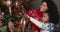 African mom and daughter decorating Christmas tree at home