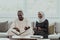 African Muslim couple at home in Ramadan reading Quran holly Islam book.