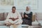 African Muslim couple at home in Ramadan reading Quran holly Islam book.