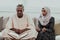 African Muslim couple at home in Ramadan reading Quran holly Islam book.