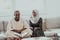 African Muslim couple at home in Ramadan reading Quran holly Islam book.