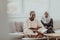 African Muslim couple at home in Ramadan reading Quran holly Islam book.