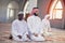 African Muslim Couple Praying inside of beutiful mosque