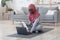 African Muslim Woman Choosing Online Tutorials On Laptop For Training At Home