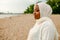 African Muslim Woman In White  Enjoying The Beach