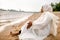 African Muslim Woman In White  Enjoying The Beach