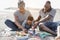 African parents and little son having fun with didactic games on the beach - Main focus on mother hands