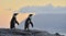 The African penguins in evening twilight with sunset sky.