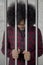 African prisoner standing behind bars