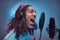 African Rastafarian singer male wearing a blue shirt and beanie emotionally writing song in the recording studio.