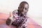 African schoolboy giving the thumbs up in front of White Background