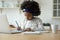 African schoolgirl in headphones do homework listen audio lesson