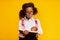 African Schoolgirl Learning To Read Holding Book Standing In Studio