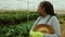 African senior farmer working inside the greenhouse