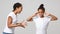 African sisters fighting over grey studio background