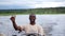 African smiling man driving a boat cruise on Chobe river in Botswana.