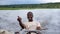 African smiling man driving a boat cruise on Chobe river in Botswana.