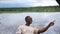 African smiling man driving a boat cruise on Chobe river in Botswana.