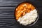 African stew Domoda with peanuts cooked with chicken pumpkin and served with rice close-up in a plate. Horizontal top view