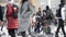 An African street vendor helps an Arabic family tourist family feed pigeons in front of the Duomo, one of the biggest