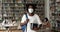African student guy wear face mask posing in campus library