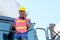 African technician worker use walky-talkie to communicate with his co-worker and stay on big truck in cargo shipping area