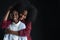 African teen siblings boy and girl hugging with smiley face on black background