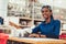 African textile worker sewing on production line