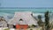 African Traditional House with Thatched Roof on the Beach at Low Tide. Zanzibar