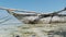 African Traditional Wooden Boat Stranded in Sand on Beach at Low Tide, Zanzibar