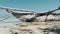 African Traditional Wooden Boat Stranded in Sand on Beach at Low Tide, Zanzibar