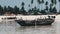 African Traditional Wooden Boat Stranded in Sand on Beach at Low Tide, Zanzibar