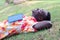 African traveler man lying sleep on the grass with opened book