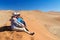 African vacation holiday, tourists sitting on dune, couple in Namib desert dunes and lanscape, travel in Namibia, Africa