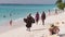 An African wears and sells flip flops to tourists on a Zanzibar beach, Tanzania