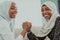 African woman arm wrestling conflict concept, disagreement and confrontation wearing traditional islamic hijab clothes