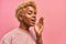 African woman with blonde hair on pink studio background scream with happiness