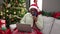 African woman with braided hair doing christmas online shopping with laptop at home