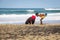 African woman and child catching crabs