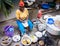 African woman cooking traditional food on street