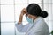 African woman doctor American wearing masks is getting a headache because of the hard work