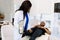 African woman doctor orthopedist examining patient in clinic. Close-up of female physiotherapist examining the leg of