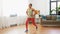 African woman doing lunge exercise at home